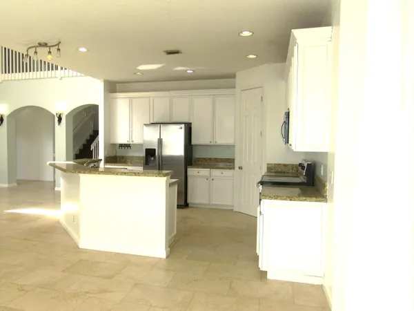 a kitchen with kitchen island cabinets and sink