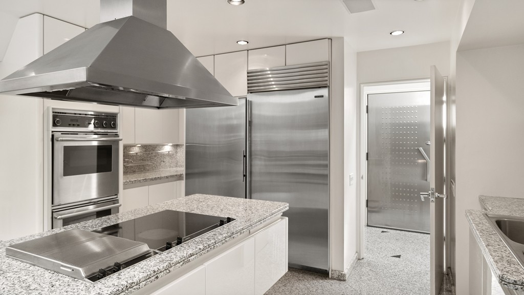 1 Wits End Road Weston, MA 02493 - Photo 8 of 21 a kitchen with stainless steel appliances granite countertop a sink and a refrigerator