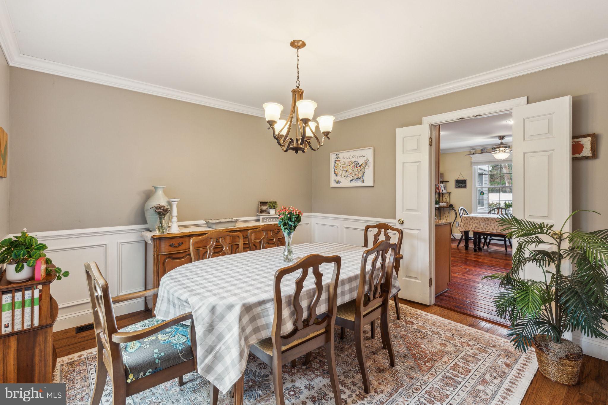 25 Wallingford Way Shamong, NJ 08088 - Photo 11 of 65 a dining room with furniture a chandelier and wooden floor