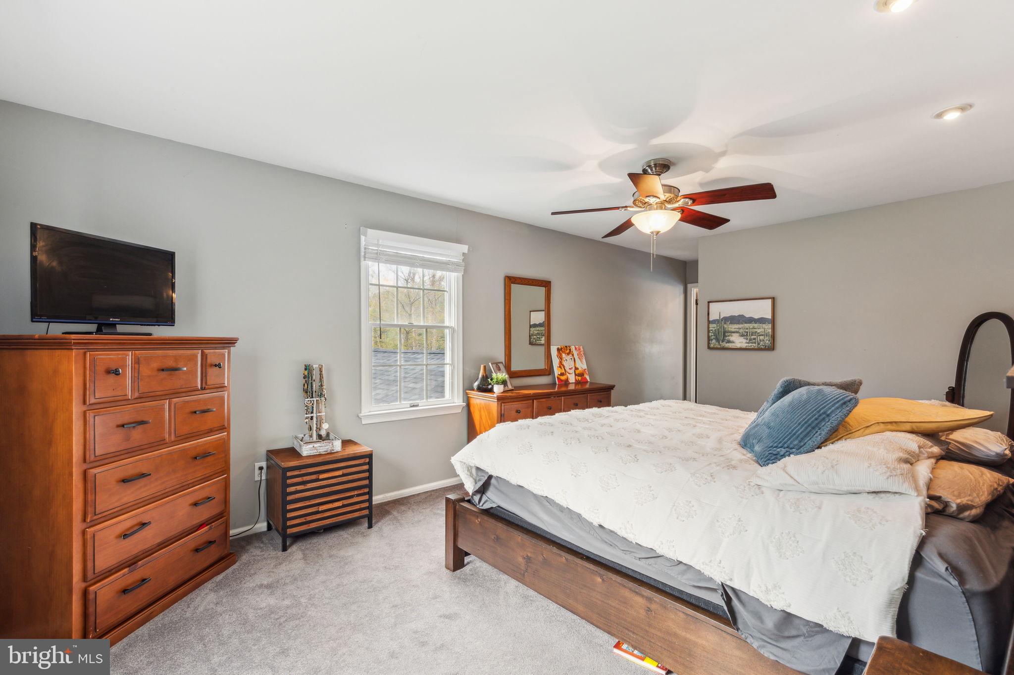 25 Wallingford Way Shamong, NJ 08088 - Photo 36 of 65 a bedroom with a bed and a flat screen tv