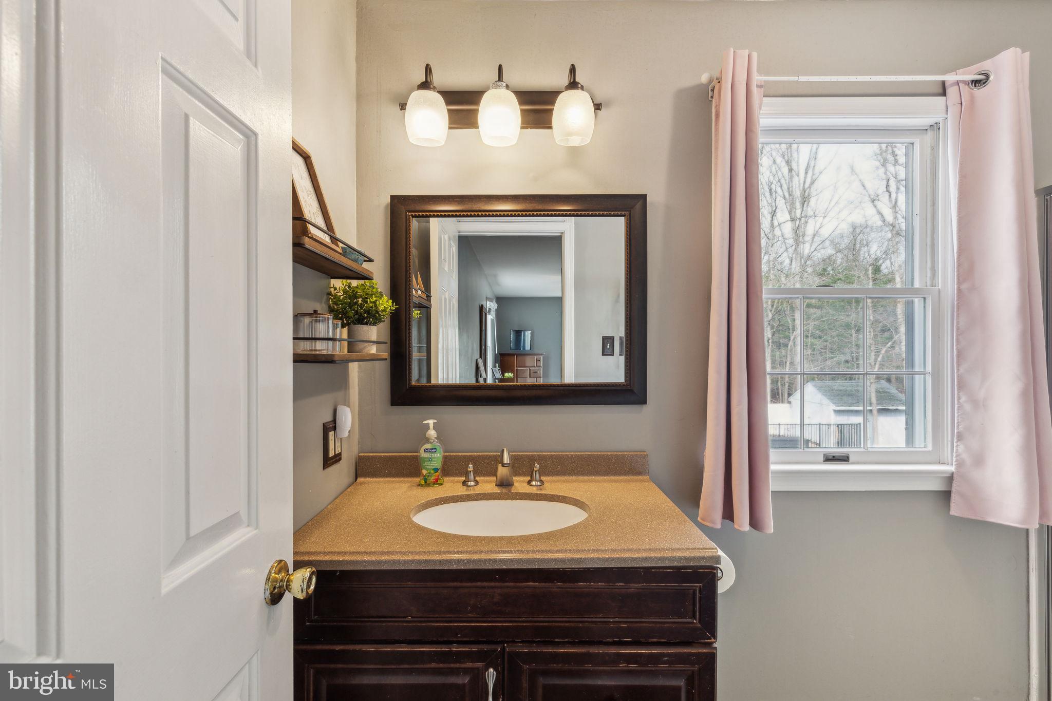 25 Wallingford Way Shamong, NJ 08088 - Photo 46 of 65 a bathroom with a granite countertop sink and a mirror