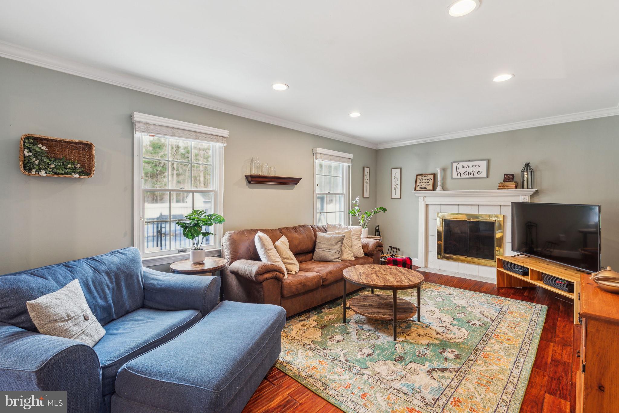 25 Wallingford Way Shamong, NJ 08088 - Photo 7 of 65 a living room with furniture a flat screen tv and a fireplace