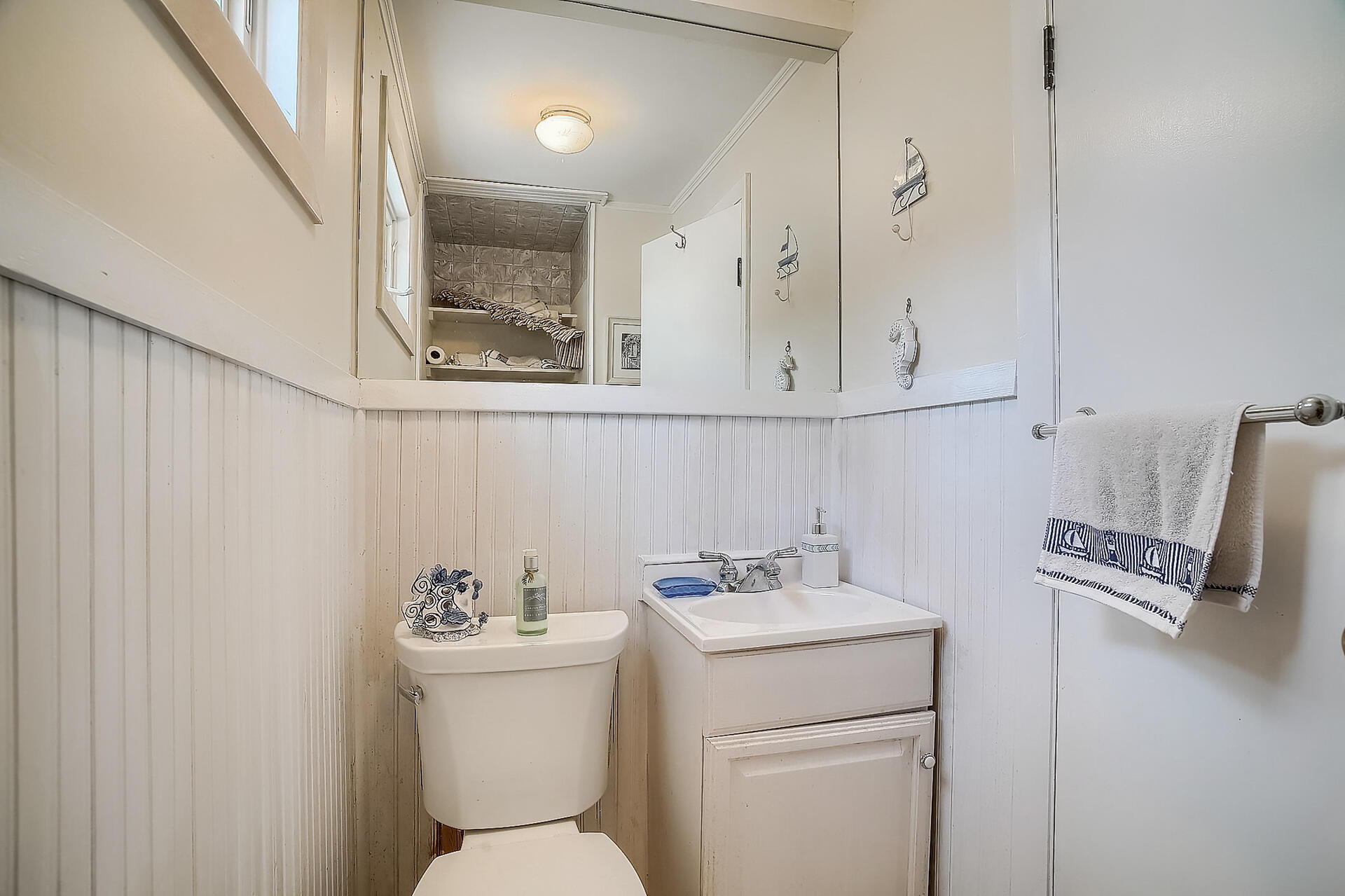 178 Main Street Orleans, MA 02653 - Photo 20 of 34 a bathroom with a sink mirror and toilet