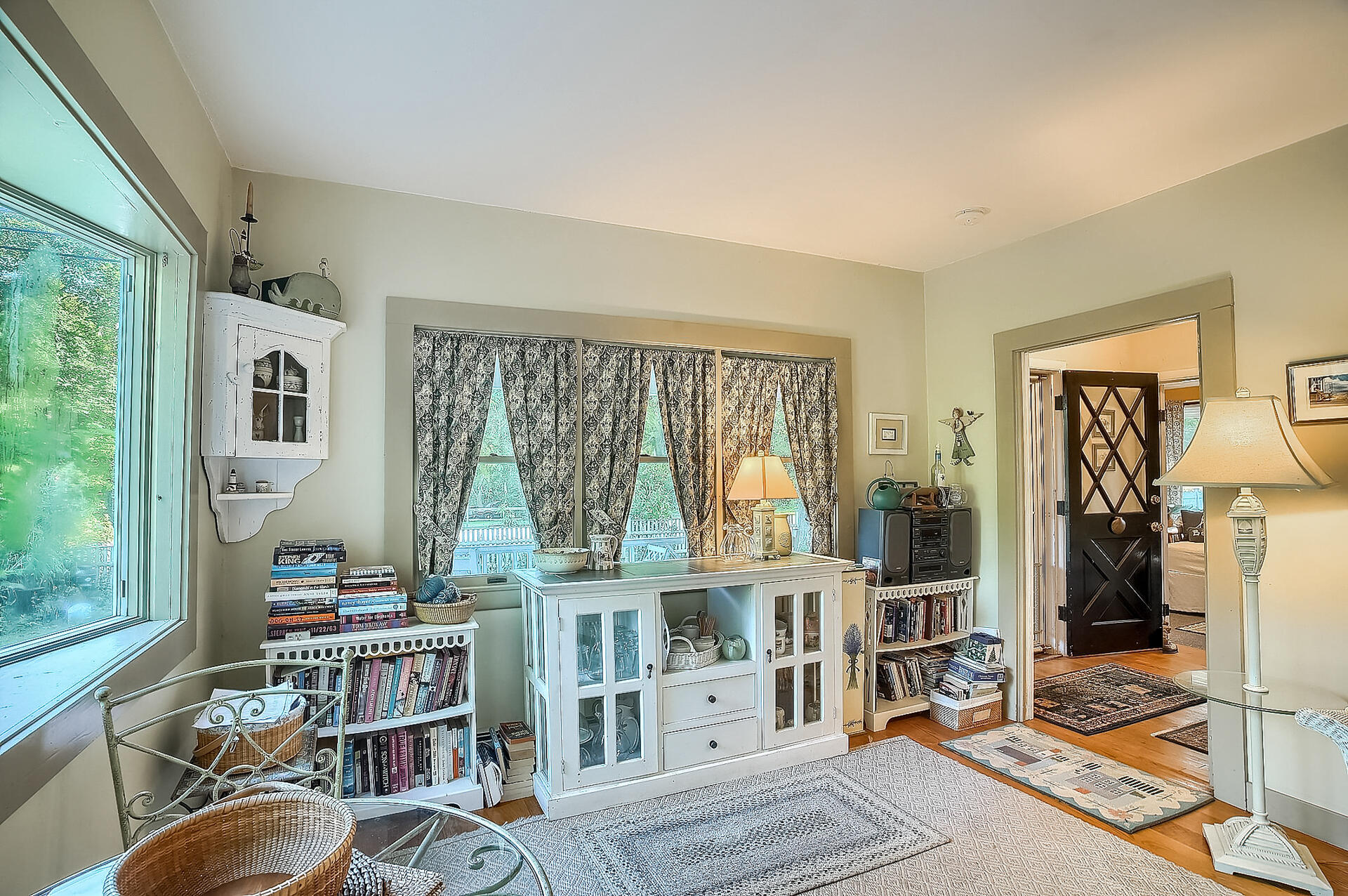 178 Main Street Orleans, MA 02653 - Photo 22 of 34 a living room with furniture a bookshelf and a window