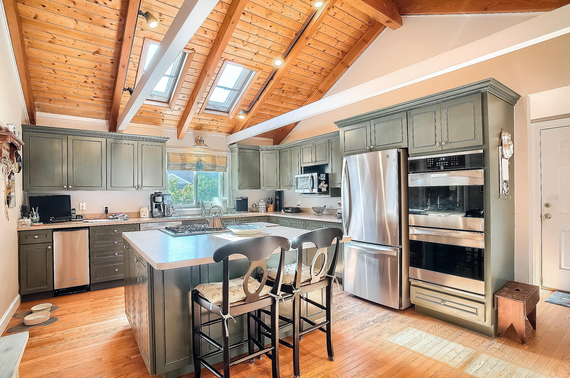 178 Main Street Orleans, MA 02653 - Photo 10 of 34 a kitchen with stainless steel appliances granite countertop a table chairs stove and refrigerator