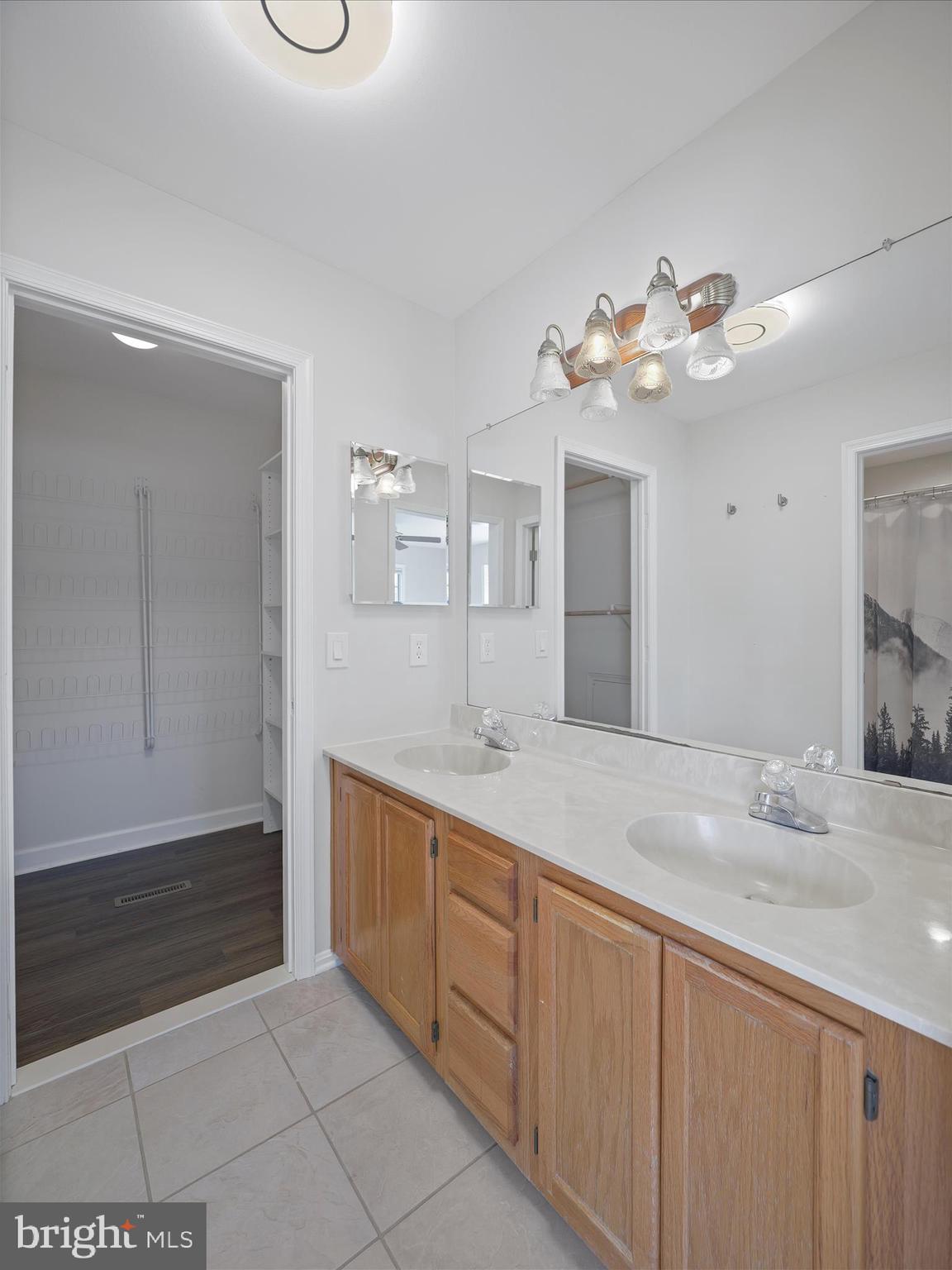4614 Newington Road Jefferson, MD 21755 - Photo 17 of 35 a bathroom with a double vanity sink and a mirror