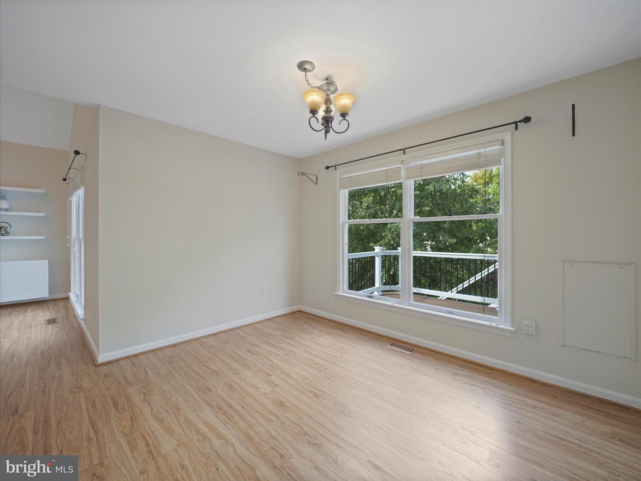 4614 Newington Road Jefferson, MD 21755 - Photo 10 of 35 a view of an empty room with wooden floor and a window