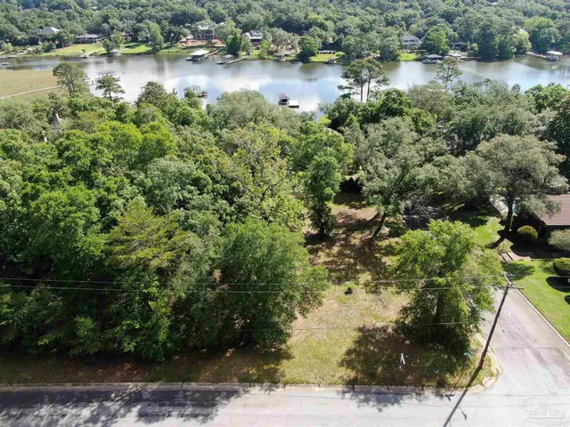 a view of a lake with beach and tree