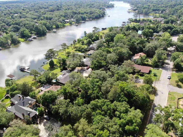an aerial view of a houses with a lake view