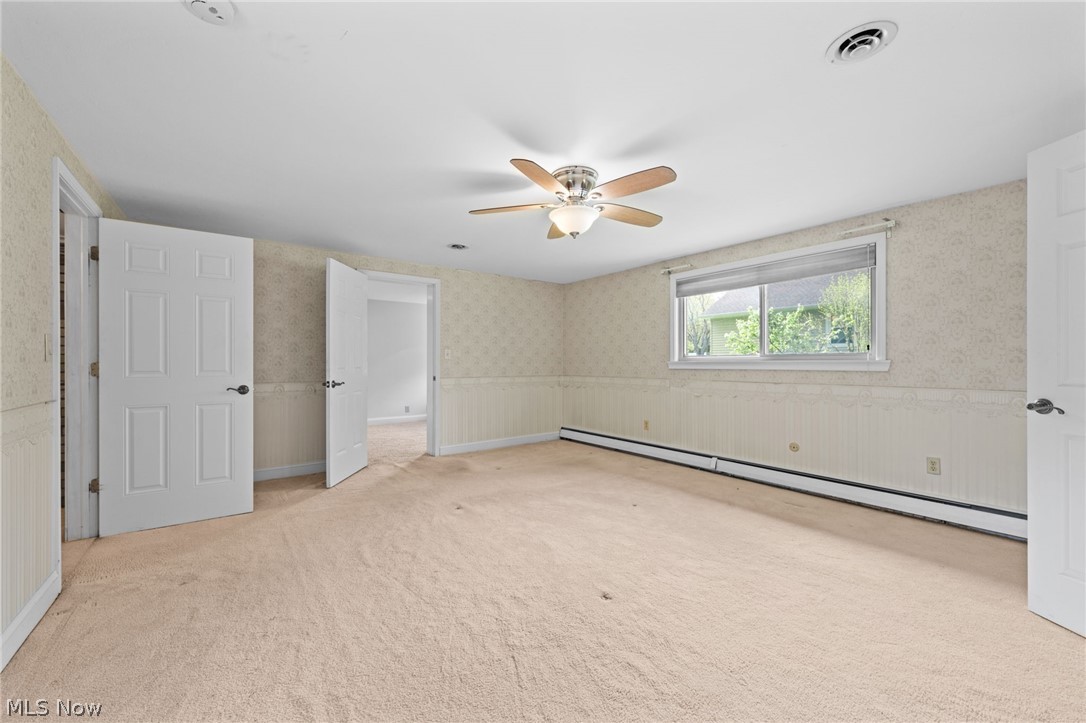 8106 Middlesex Road Mentor, OH 44060 - Photo 14 of 32 Bedroom featuring a baseboard heating unit, light carpet, and ceiling fan