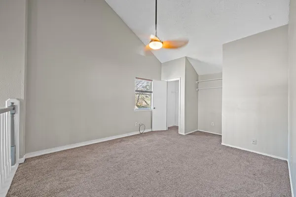 an empty room with a fan