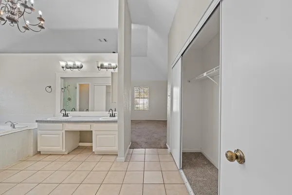 a spacious bathroom with a sink and a mirror