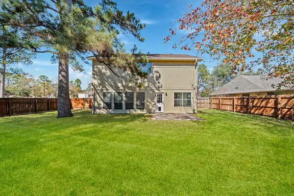 a view of a house with a backyard