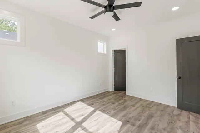 a view of a room with a window and a ceiling fan