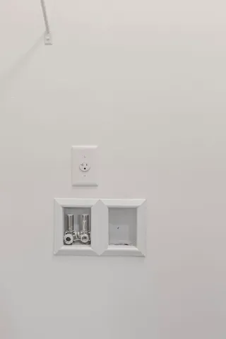 a view of a refrigerator in a white wall