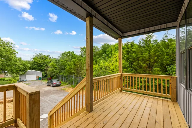 a view of a balcony with wooden floor