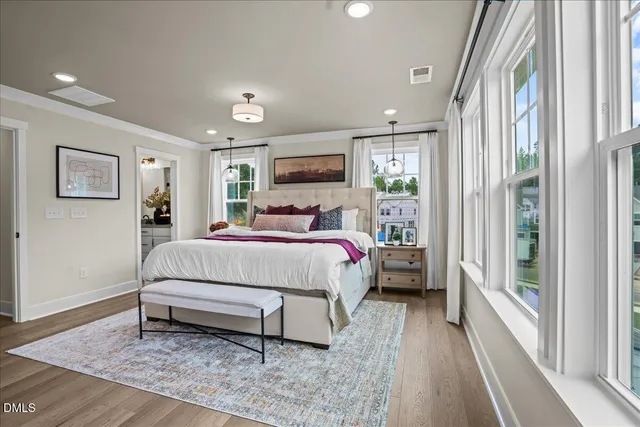 a bed sitting in a spacious bedroom next to a window