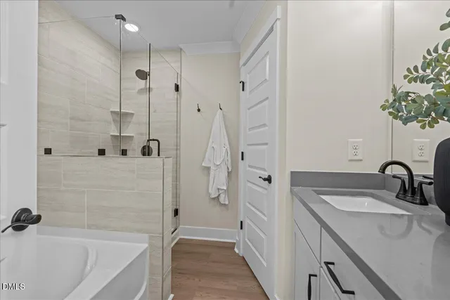 a bathroom with a granite countertop tub sink and mirror