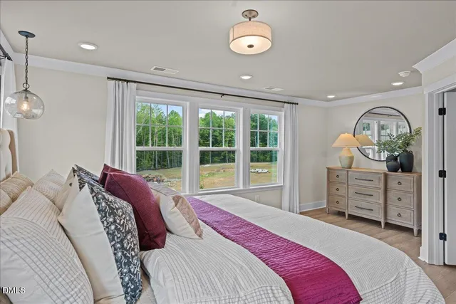 a bed room with a bed mirror and a window