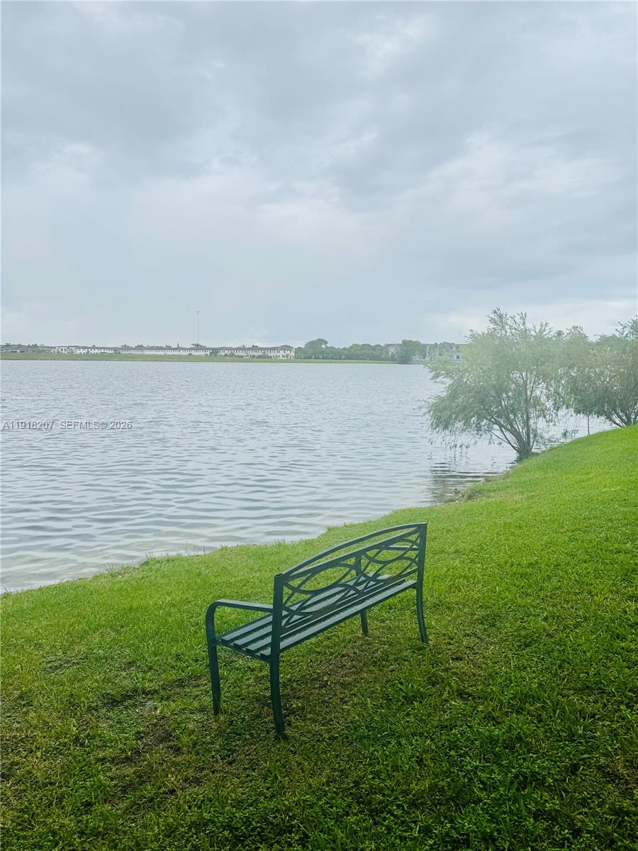 605 Ives Dairy Road, Unit 3067 Miami, FL 33179 - Photo 19 of 28 a view of a lake with outdoor space and a bench