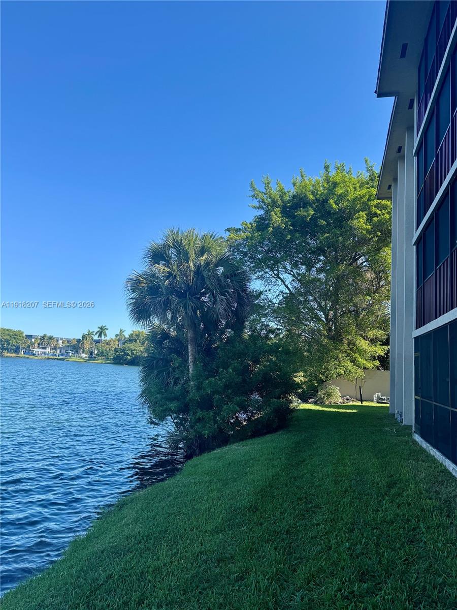 605 Ives Dairy Road, Unit 3067 Miami, FL 33179 - Photo 23 of 28 a view of a lake with a big yard