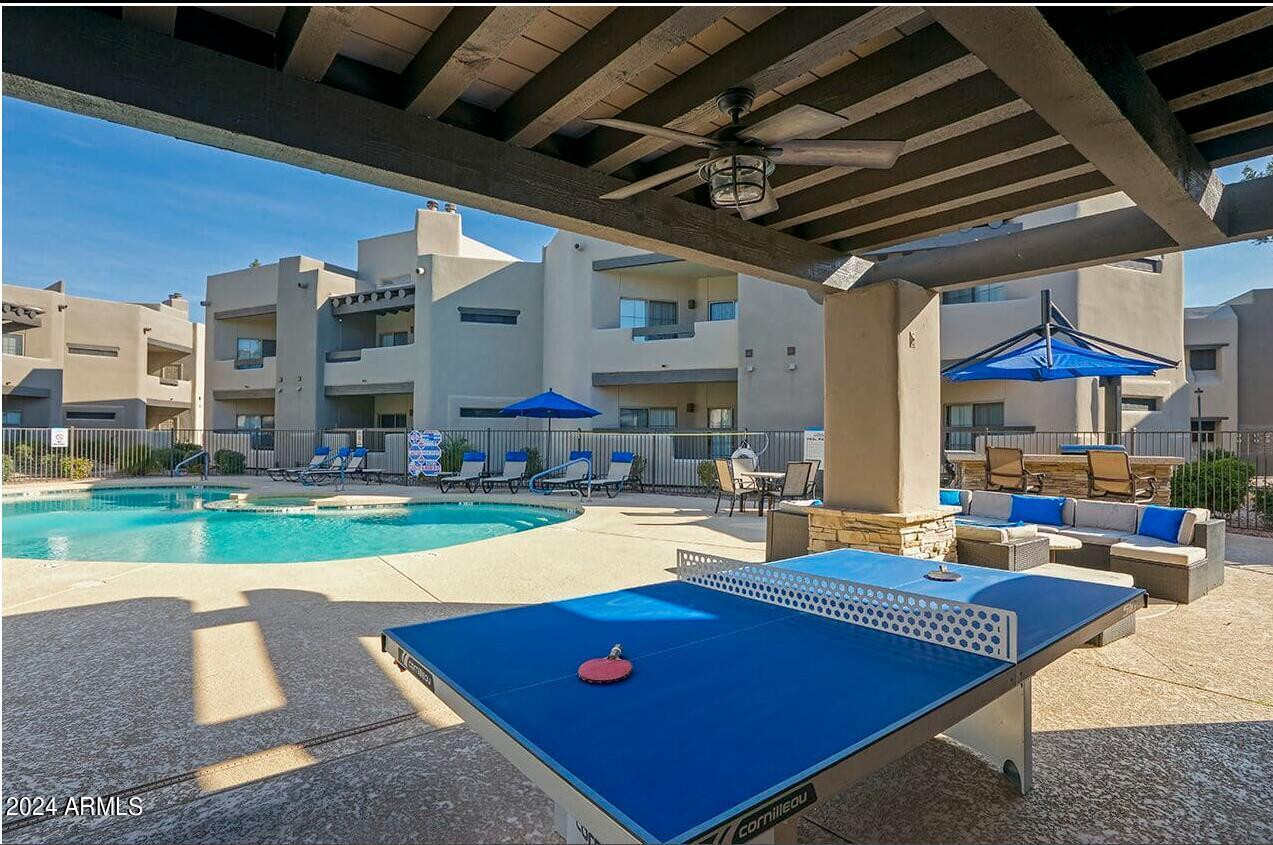 9259 East Raintree Drive, Unit 1 Scottsdale, AZ 85260 - Photo 11 of 15 a living room with lots of furniture and a table