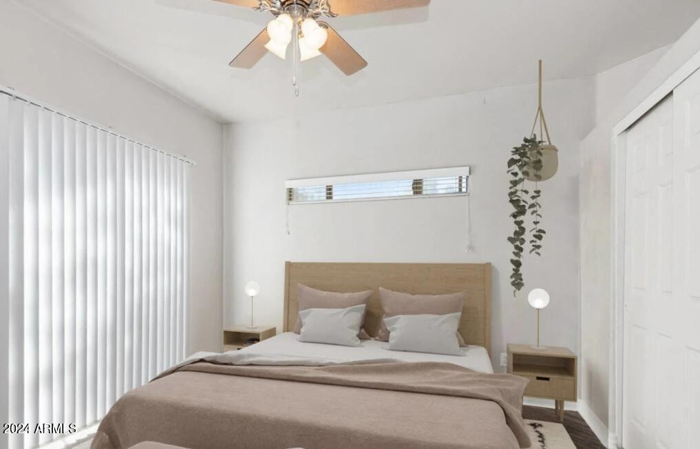 9259 East Raintree Drive, Unit 1 Scottsdale, AZ 85260 - Photo 5 of 15 a bedroom with a bed and a chandelier