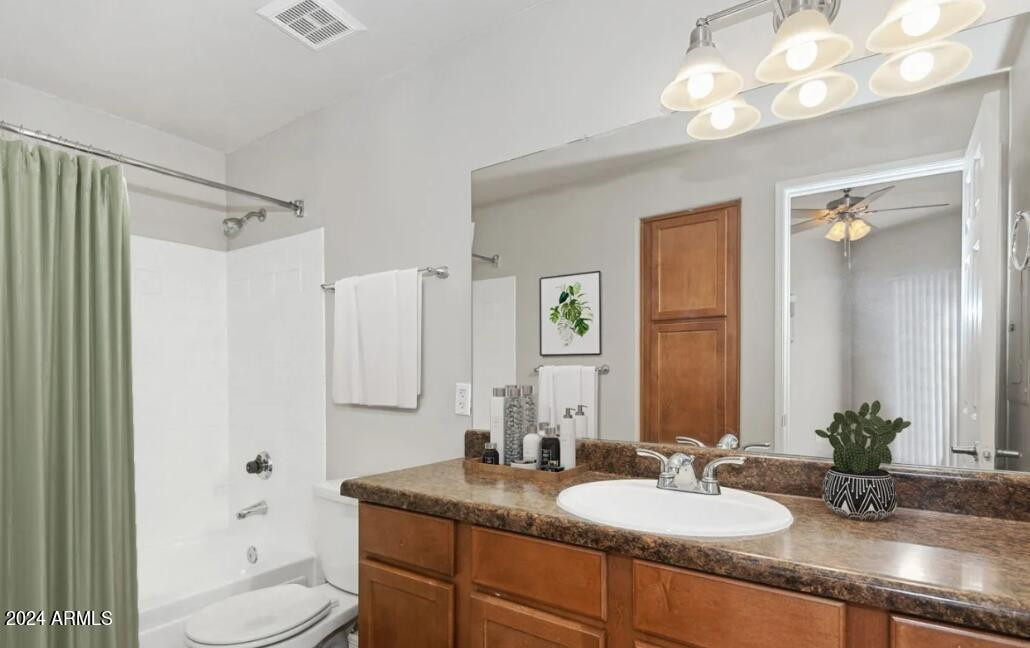 9259 East Raintree Drive, Unit 1 Scottsdale, AZ 85260 - Photo 6 of 15 a bathroom with a granite countertop sink toilet and a mirror