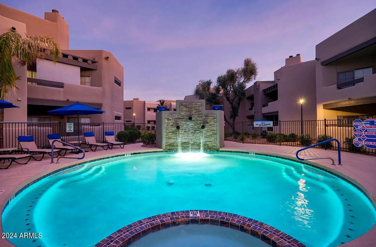 9259 East Raintree Drive, Unit 1 Scottsdale, AZ 85260 - Photo 7 of 15 a swimming pool with outdoor seating and yard