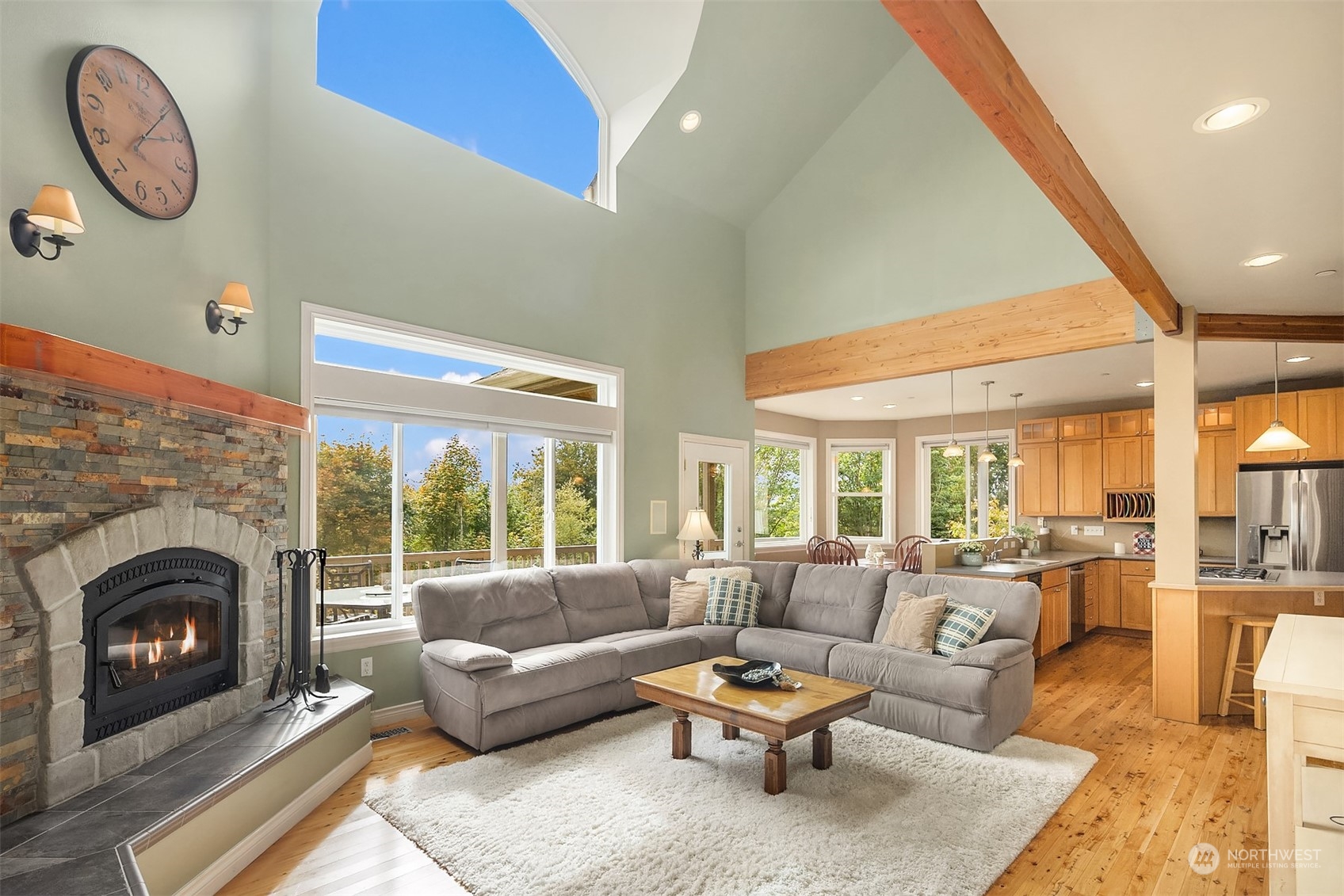 32255 Northeast 88th Street Carnation, WA 98014 - Photo 16 of 40 a living room with furniture a fireplace and a floor to ceiling window
