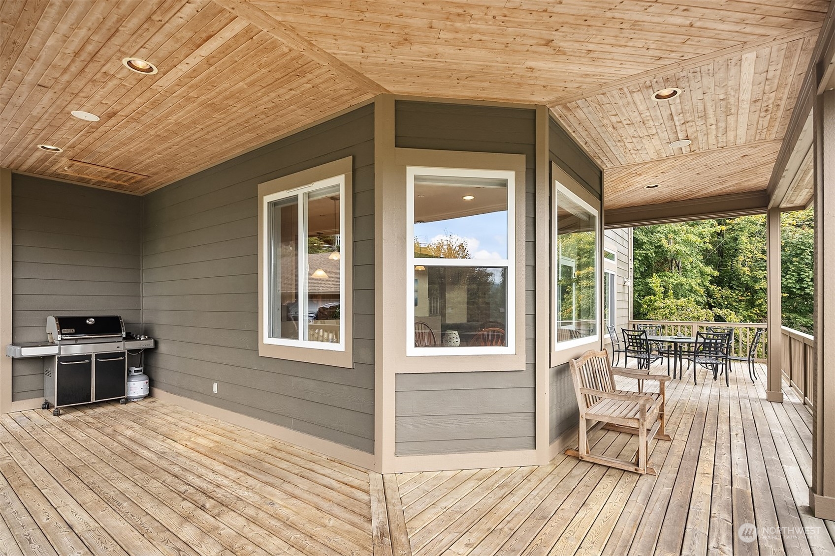 32255 Northeast 88th Street Carnation, WA 98014 - Photo 18 of 40 a view of a patio with a table chairs and wooden floor