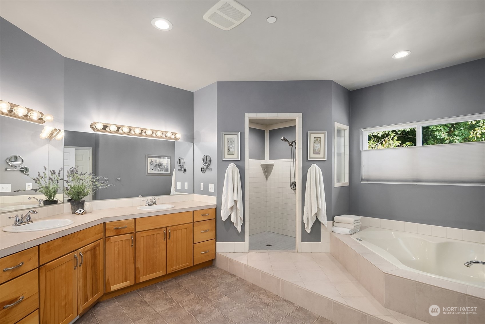 32255 Northeast 88th Street Carnation, WA 98014 - Photo 27 of 40 a spacious bathroom with a double vanity sink a mirror a bathtub and next to a window