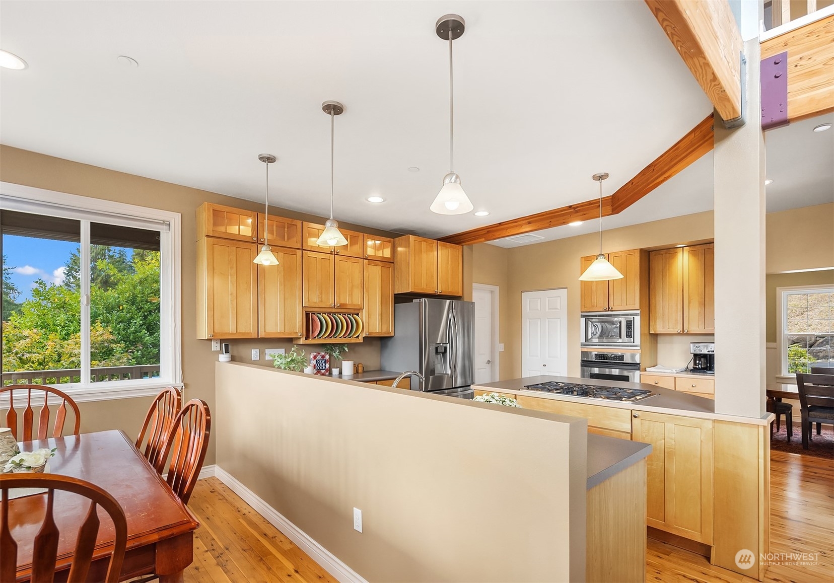 32255 Northeast 88th Street Carnation, WA 98014 - Photo 9 of 40 a kitchen with stainless steel appliances kitchen island granite countertop a stove a refrigerator a oven with white cabinets and wooden floor