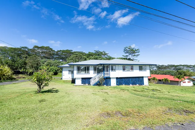 a view of a house with a yard porch and sitting area