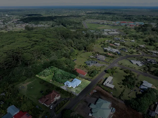 an aerial view of a house with a yard