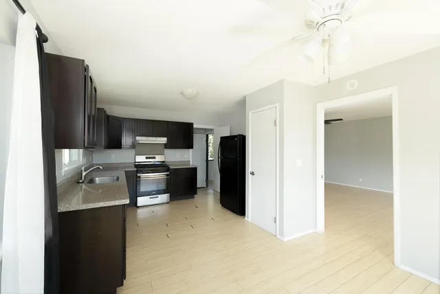 a kitchen with refrigerator and stove