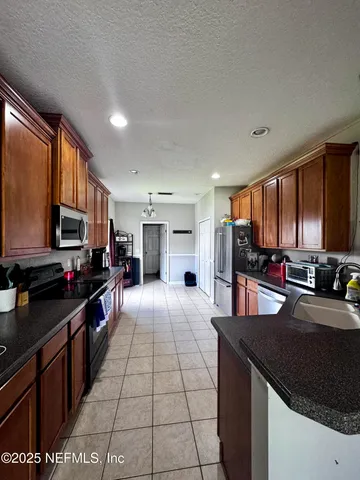 a kitchen with stainless steel appliances a sink stove and cabinets