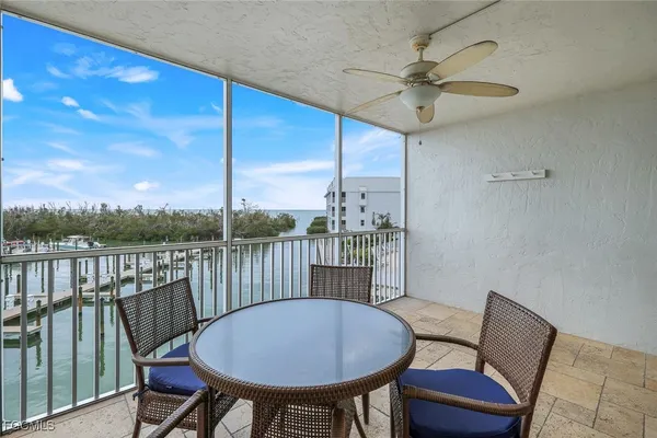 a view of a chairs and table in the balcony