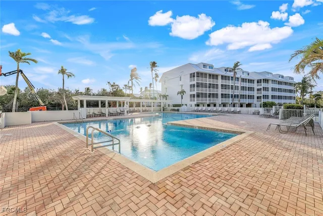 a view of a swimming pool with a lounge chair