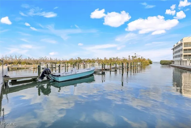 a view of a lake with a table and chairs