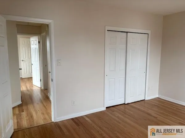 a view of hallway with wooden floor