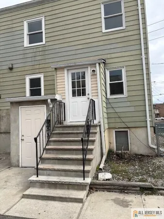 a view of a house with a small door and a large window