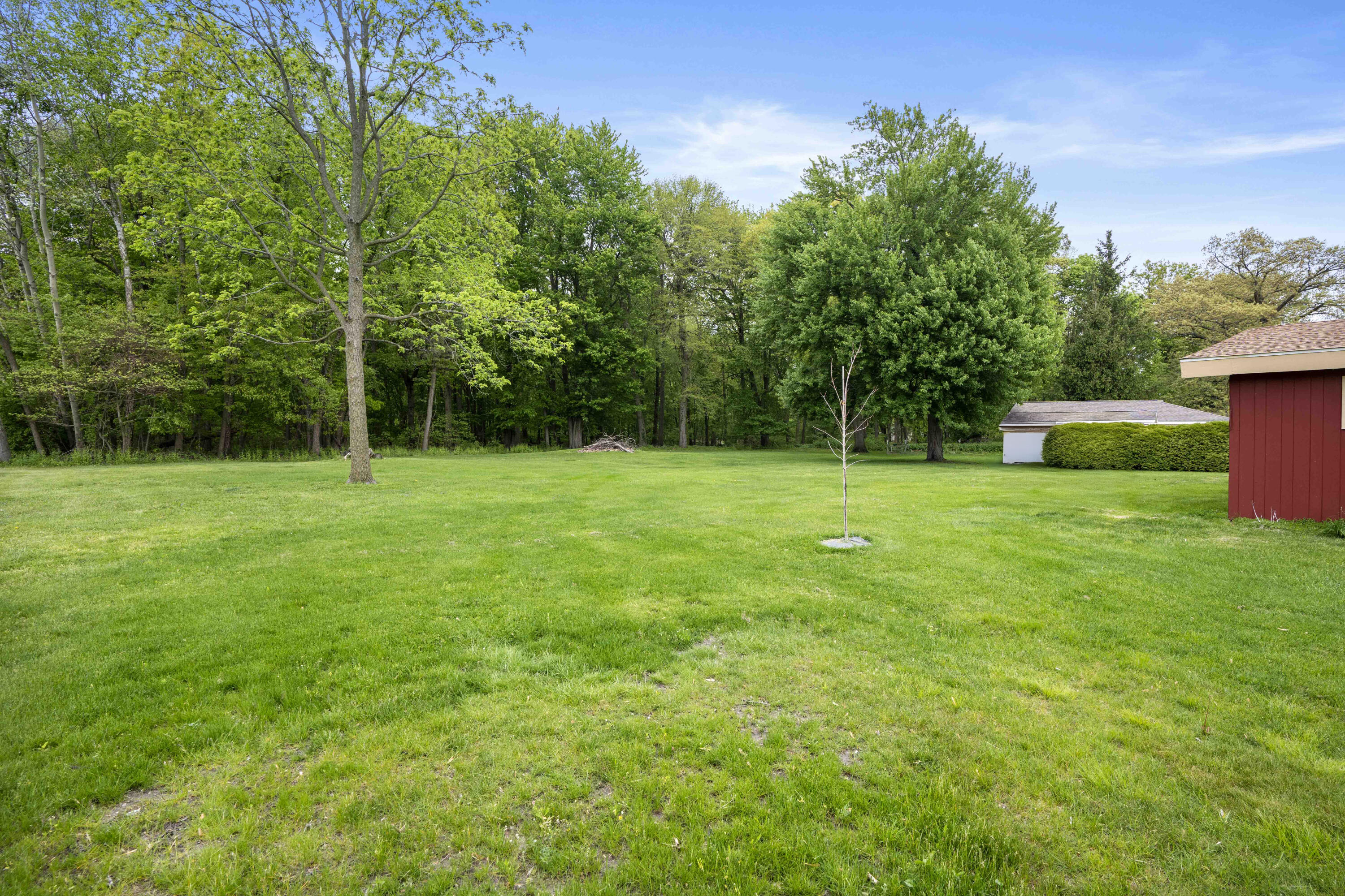 5100 South County Road 210 Knox, IN 46534 - Photo 8 of 14 a grassy field with a tree in the background
