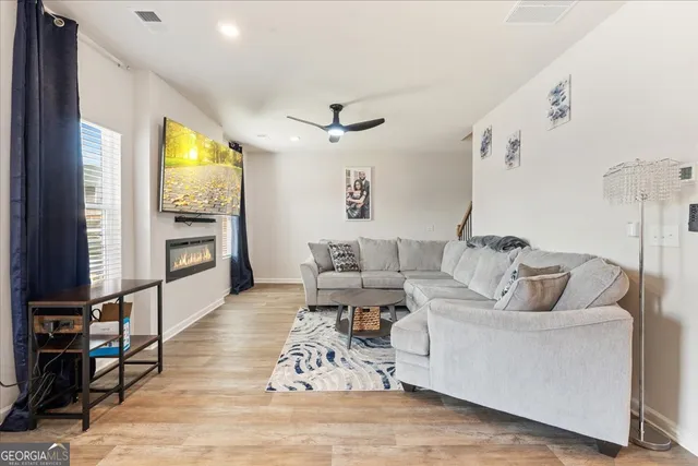 a living room with furniture window and wooden floor