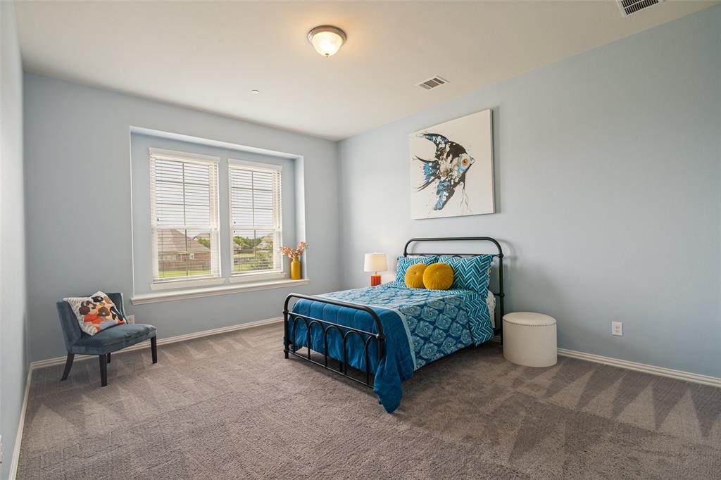 388 Bethany Road Sunnyvale, TX 75182 - Photo 28 of 40 Spacious room featuring light blue walls, two windows with white blinds, and gray patterned carpeting