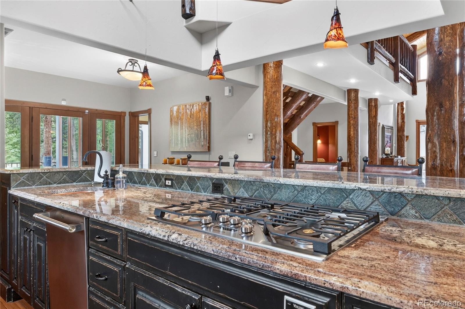148 County Road Tabernash, CO 80478 - Photo 7 of 45 a large kitchen with kitchen island granite countertop a sink and a stove