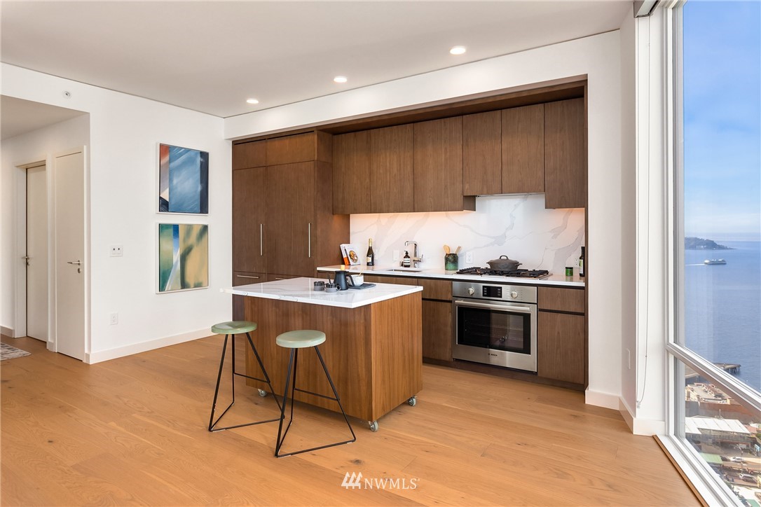 121 Stewart Street, Unit 2201 Seattle, WA 98101 - Photo 11 of 23 a kitchen with stainless steel appliances granite countertop a stove and a refrigerator