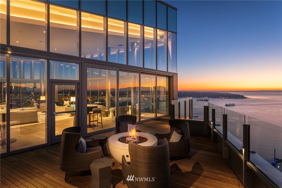 121 Stewart Street, Unit 2201 Seattle, WA 98101 - Photo 19 of 23 a living room with furniture and a floor to ceiling window