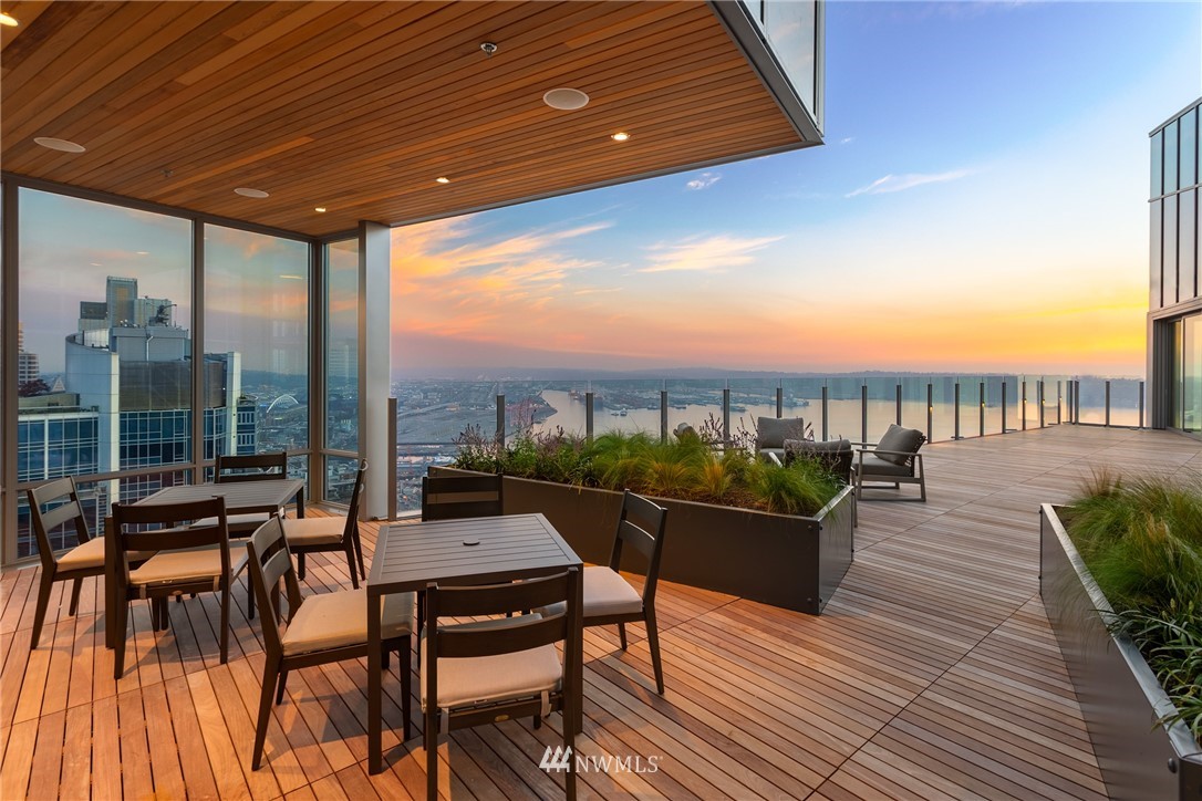 121 Stewart Street, Unit 2201 Seattle, WA 98101 - Photo 21 of 23 a living room with furniture and a floor to ceiling window