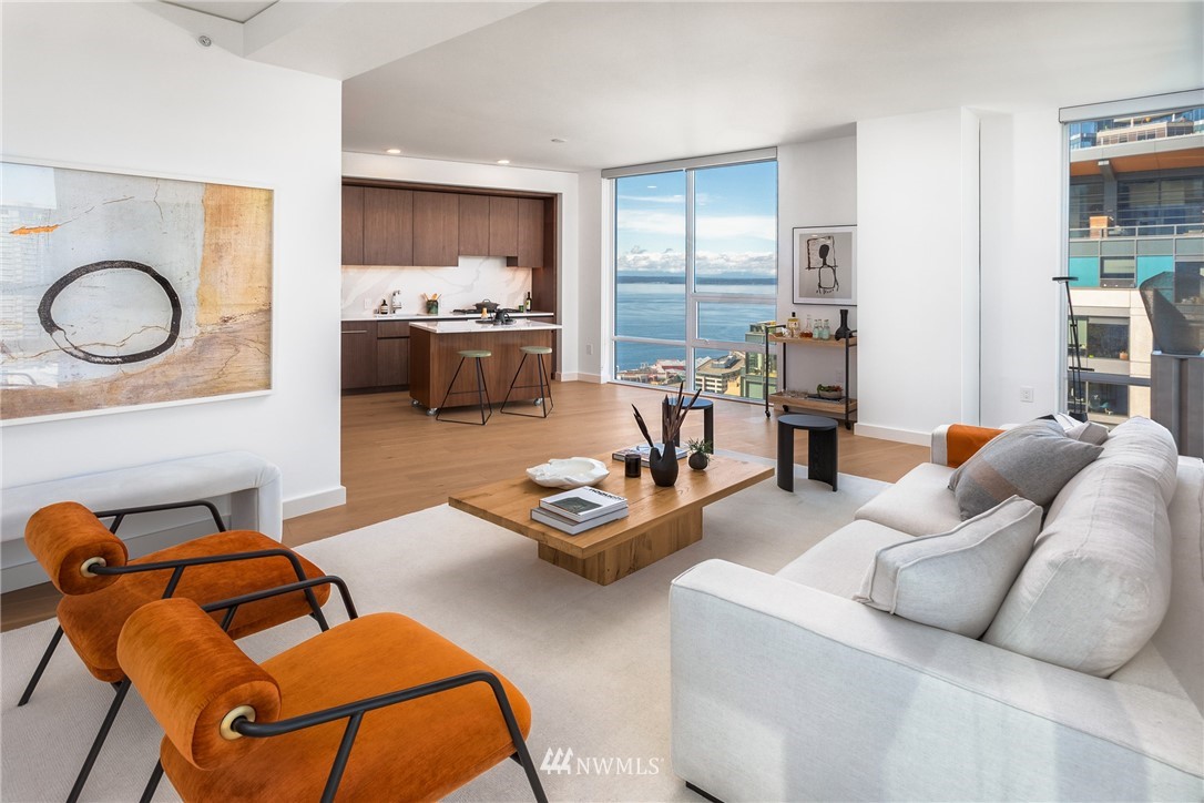 121 Stewart Street, Unit 2201 Seattle, WA 98101 - Photo 5 of 23 a living room with furniture and kitchen view